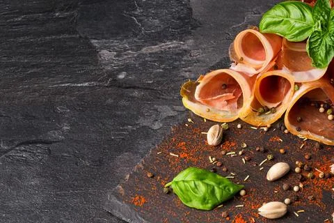 Empty seashells and herbs on dark stone surface Stock Photos