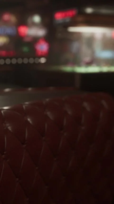 Empty seating area in a bar during evening hours with blurred background Stock Footage 337975748