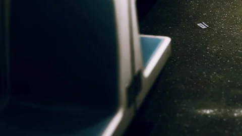 Empty seating area in public transport with trash on the floor during night Stock Footage 340617985
