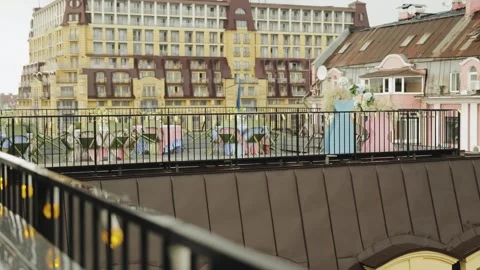 Empty seating area on the terrace of a cafe with a view of the city on a rainy Stock Footage 318064856