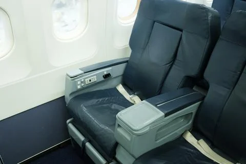 Empty seats in an airplane cabin wait for passengers, showcasing the clean an Stock Photos