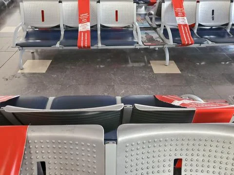 Empty seats and red caution tape in waiting area of Antalya airport Stock Photos