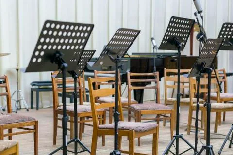 Empty seats and some instruments in music hall awaiting orchestra to come on  Stock Photos