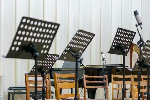 Empty seats and some instruments in music hall awaiting orchestra to come on  Stock Photos