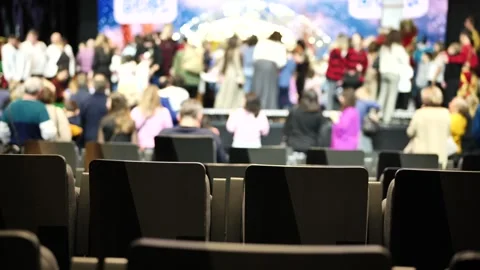 Empty seats in auditorium viewing blurry crowd attending conference or seminar Stock Footage 330009576
