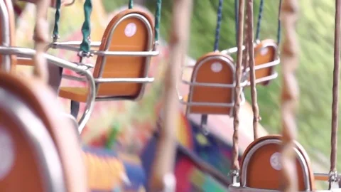 Empty seats on the carousel in the amusement park view from the inside Stock Footage 76834934