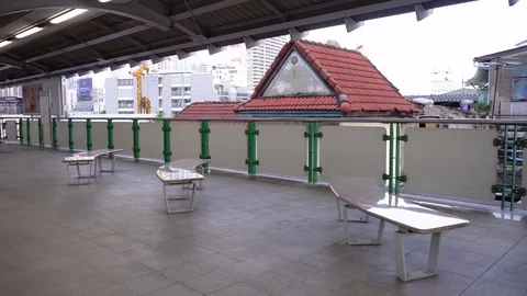 Empty seats at elevated train station with city skyline in background Stock Footage 82776690