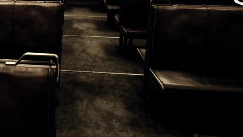 Empty seats fill a dimly lit train carriage at night Stock Footage 340617312