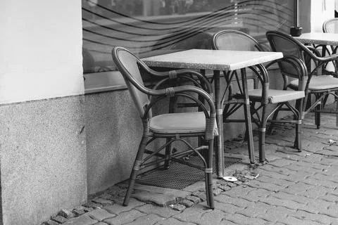 Empty seats in front of a street cafe in a city Stock Photos