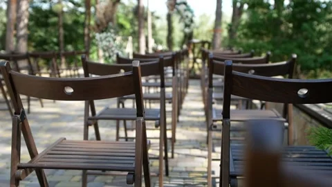 Empty seats for guests on the background of the wedding arch. Stock Footage 137948519