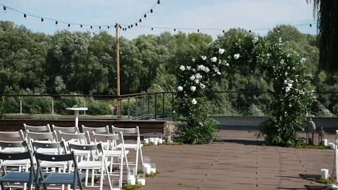 Empty seats for guests on the background of the wedding arch. Stock Footage 149428337