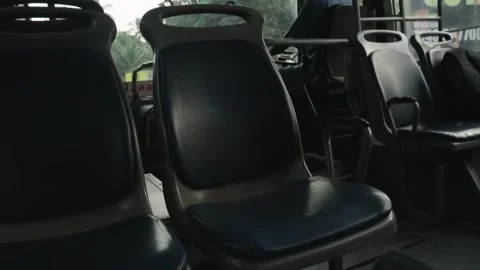 Empty seats on a moving bus traveling down a road Stock Footage 345898290