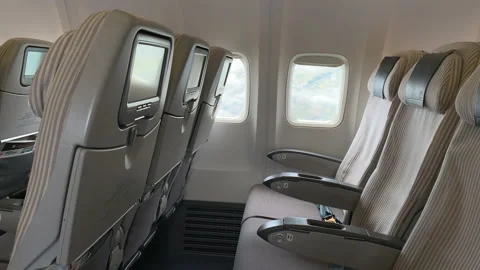 Empty seats in a passenger airplane during flight. View through the window. Stock Footage 209138164
