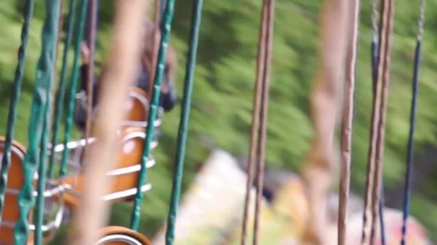 Empty seats of a rotating carousel on chains in an amusement park Stock Footage 76834597