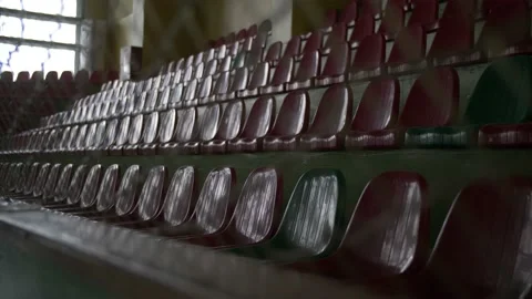 The empty seats of the stands of the old dark sports hall. Stock Footage 170832074