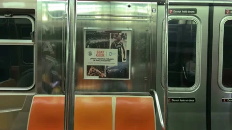 Empty seats on subway train riding through dark tunnel New York City 库存影片 165136972