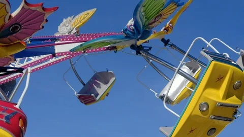 Empty seats on thrilling ride during dayligt at funfair in Germany Stock Footage 96150598