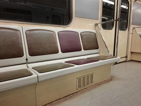 Empty seats without passengers in an empty subway car moving through tunnel Fotos de archivo