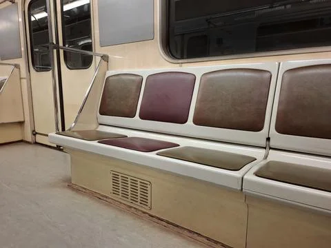 Empty seats without passengers in an empty subway car moving through tunnel Stock Photos