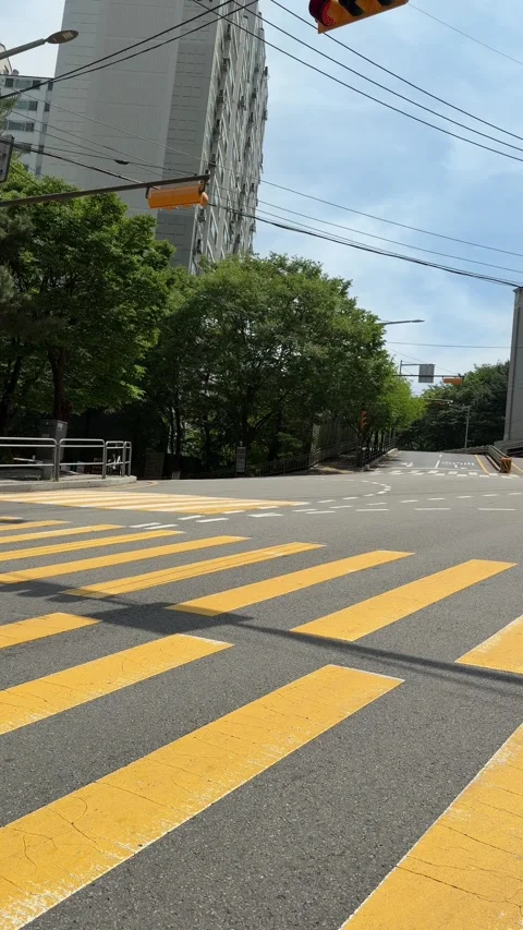 Empty Seoul Intersection With Yellow Crosswalk on a Sunny Summer Day Stock Footage 339908043