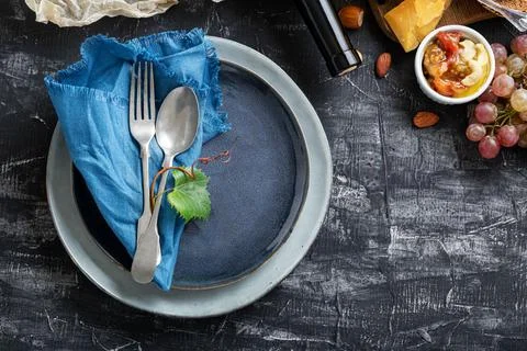 Empty serving blue plate with fork spoon in frame of food ingredients Mediter Stock Photos