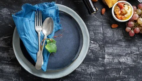 Empty serving blue plate with fork spoon in frame of food ingredients Mediter Stock Photos