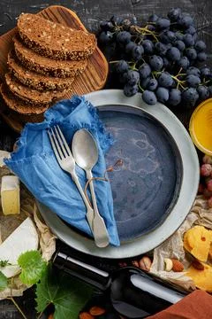 Empty serving blue plate with fork spoon in frame of food ingredients gastronomy Stock Photos