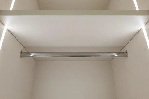 An Empty Shelf Featuring a Chrome Rod Perfect for Hanging Various Items and Stock Photos