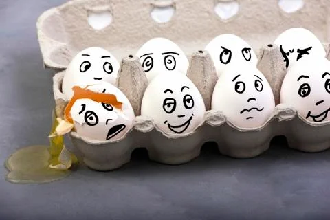 An empty shell, broken egg with different faces. Eggs in box Stock Photos