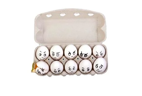 An empty shell, broken egg with different faces. Eggs in box Stock Photos
