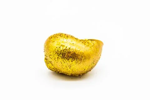 Empty shell of a snail in the gold glitter against white background. Snail sh Stock Photos