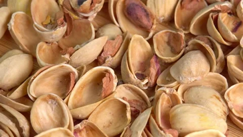 Empty shells without pistachios top view rotation. Pistachio husks top view. Video stock 209537489