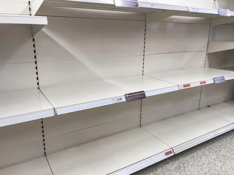 Empty shelves stand in quiet rows Stock Photos