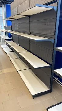 Empty shelves in the store. Interior of a modern shopping center. Stock Photos