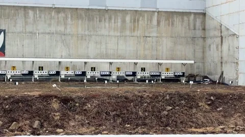 Empty shooting range with multiple booths and concrete wall Stock Footage 307721968