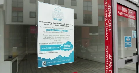 Empty shop displaying a notice that branch is temporarily closed due to COVID-19 Stock Footage 147625952