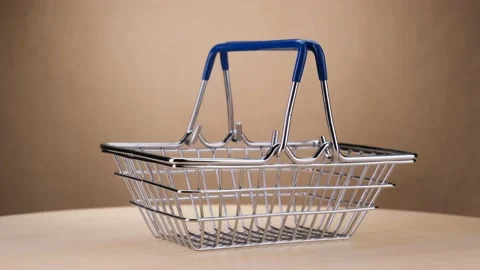 Empty shopping basket rotates on a round table. Studio shot. 4k Stock Footage 157084718