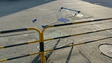 Empty Shopping Cart Abandoned in Parking Lot Urban Retail Scene 스톡 동영상 342782260