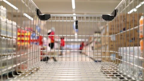 Empty shopping cart moving through supermarket Stock Footage 294993372