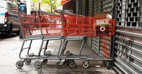 Empty shopping carts in front of closed business during covid Stock Footage 229808910