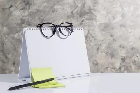 Empty side of desk calendar and blank notes, glasses, pen Stock Photos