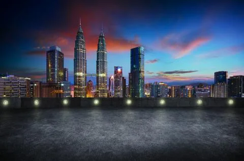 Empty side view asphalt car park with kuala lumpur city skyline , night scene Stock Photos