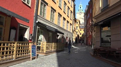 Empty sidewalk cafes and church in Gamla Stan Stock Footage 44151763