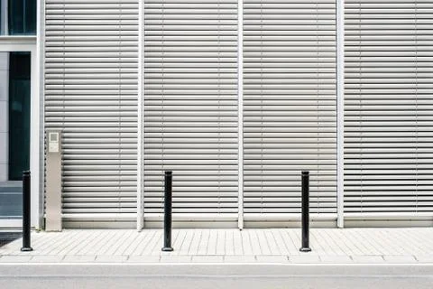 Empty sidewalk with modern building background with closed venetian blinds Stock Photos