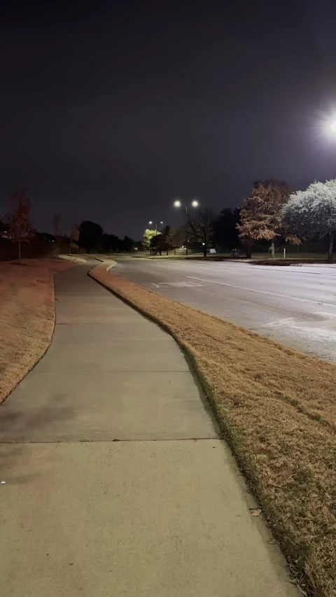 Empty Sidewalk at Night Under Streetlight With Quiet Urban Mood Video stock 325333135