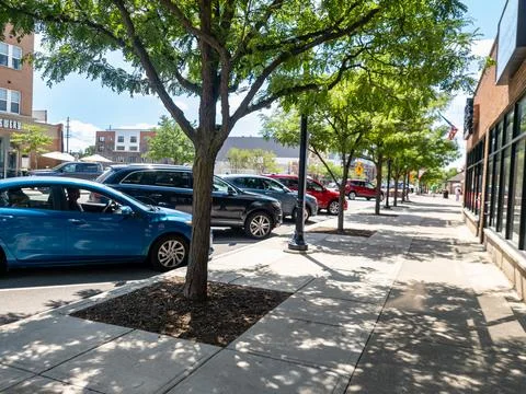 Empty Sidewalk with trees and parked cars on Auburn road in downtown Auburn.. Stock Photos