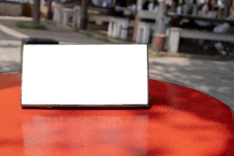 Empty sign on red rustic bar table at outdoor cafe Stock Photos