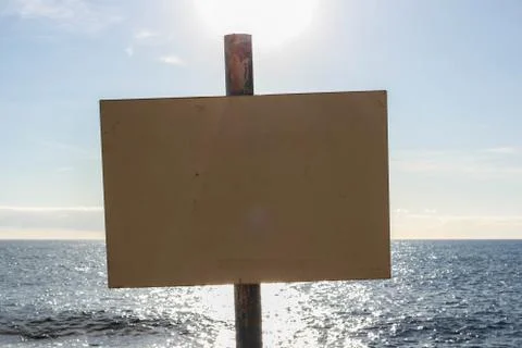 An empty sign with water in the background Stock-Fotos