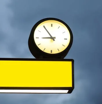 Empty signboard and clock over blue sky background Empty signboard and clo... 스톡 사진