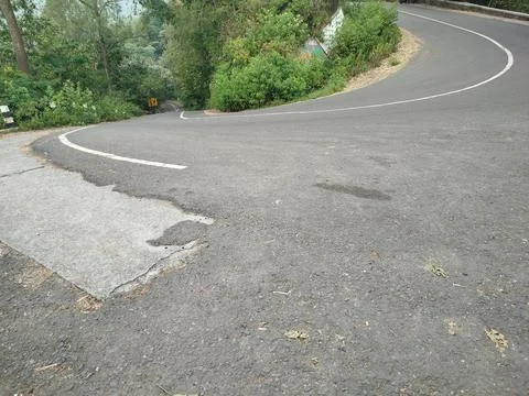 An empty silent highway in the middle of a forest mountain 스톡 사진